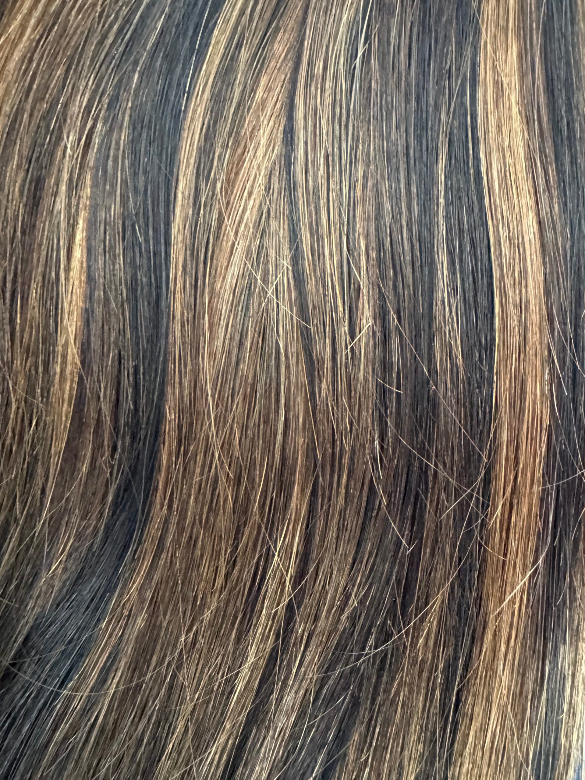 Close-up of brown hair with highlights