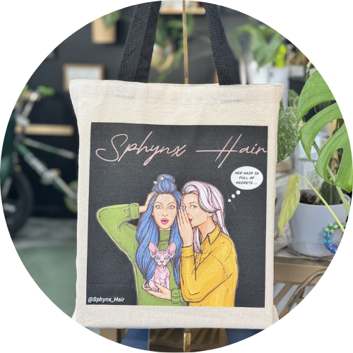 Tote bag with illustration of two people and a dog, featuring 'Sphynx Hair' branding.