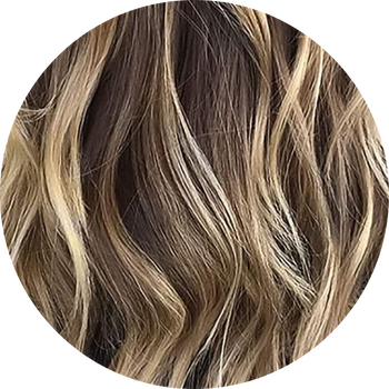 Close-up of wavy hair with brown and blonde tones.
