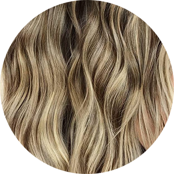 Close-up of wavy hair with brown and blonde coloration on a white background