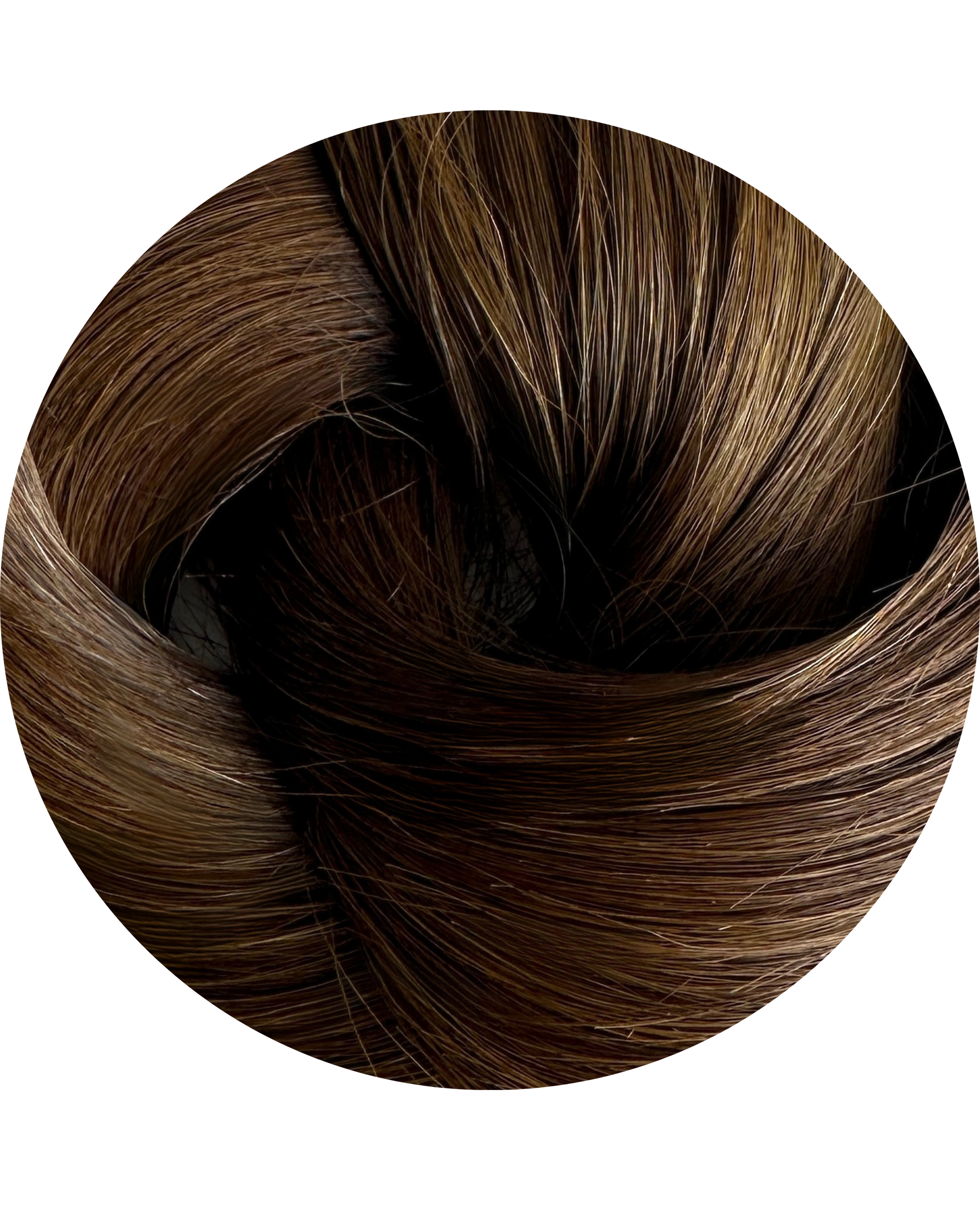 Close-up of brown hair extensions on a white background