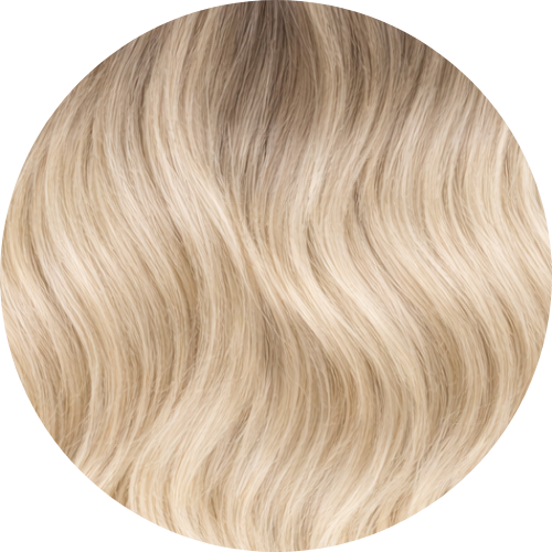 Close-up of blonde hair extension swatch with a wavy texture on a white background