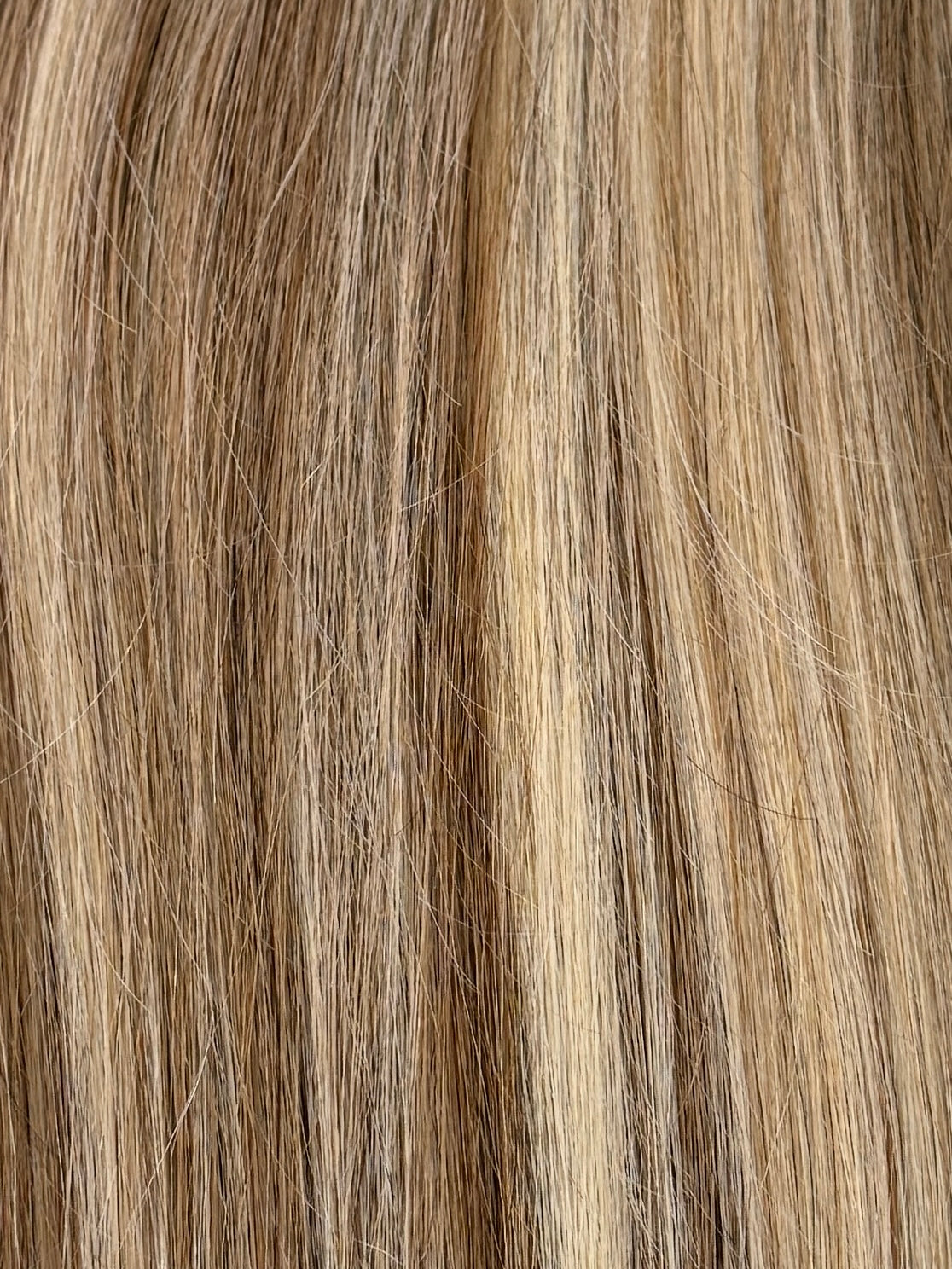 Close-up of blonde hair strands with a gradient from light to dark.