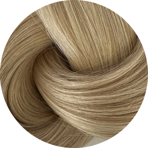 Close-up of a coil of light brown hair extensions on a white background